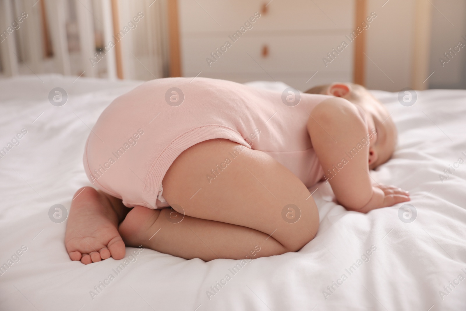 Photo of Adorable little baby sleeping on bed at home