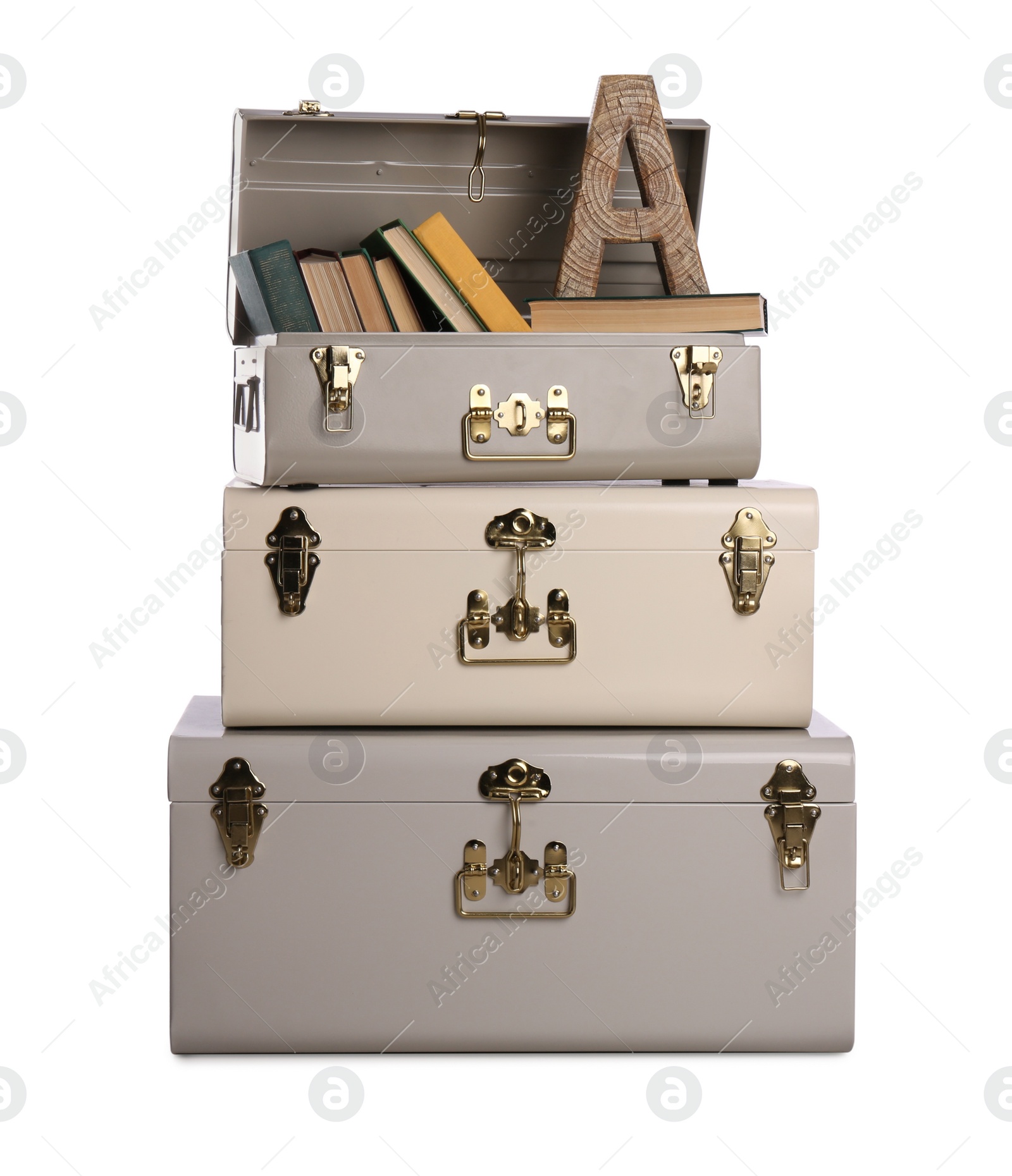 Photo of Stylish storage trunks with books and wooden letter A isolated on white