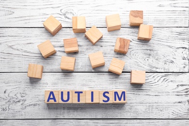 Photo of Cubes with word "Autism" on wooden background