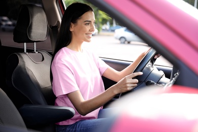 Photo of Young woman sitting in car. Driving school