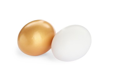 Photo of Golden egg and ordinary one on white background