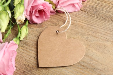 Photo of Happy Mother's Day. Beautiful flowers and blank heart shaped card on wooden table