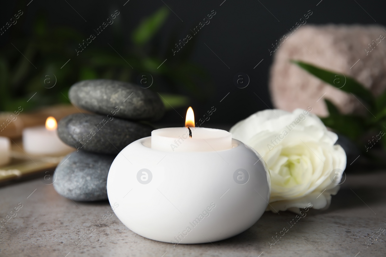 Photo of Spa composition with burning candle on table