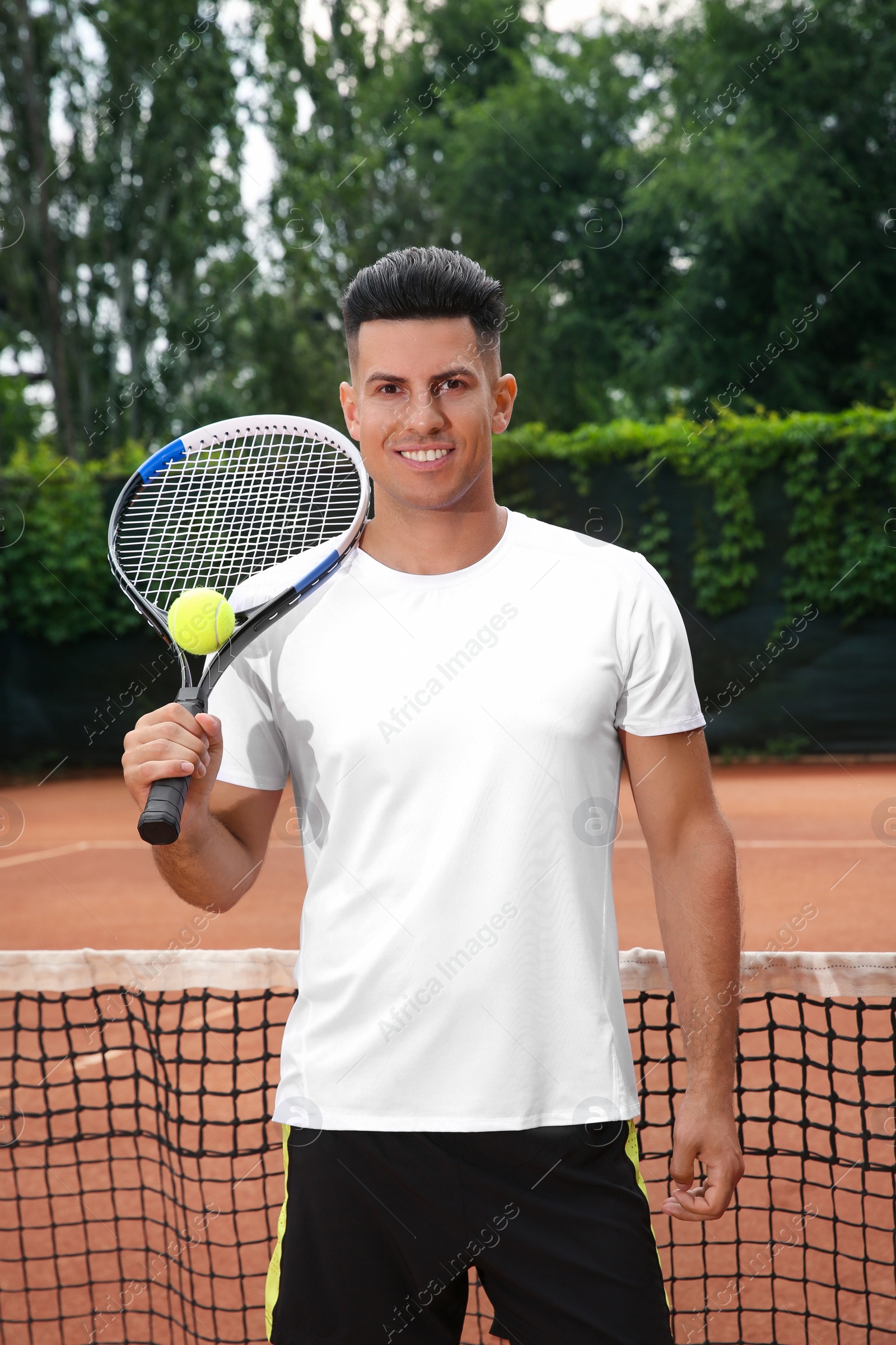 Photo of Man with racket and ball on tennis court