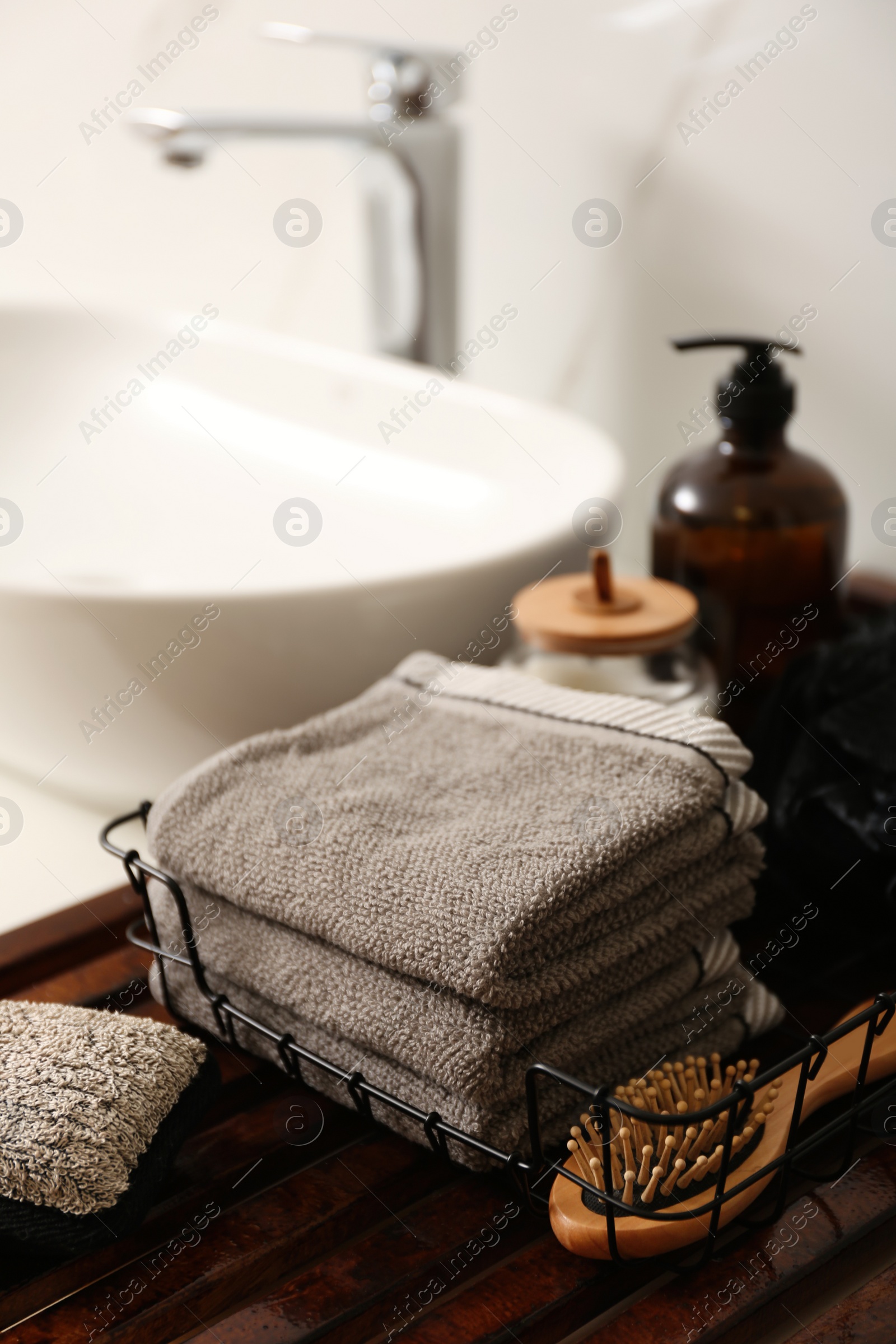 Photo of Personal hygiene products and toiletries near sink in bathroom