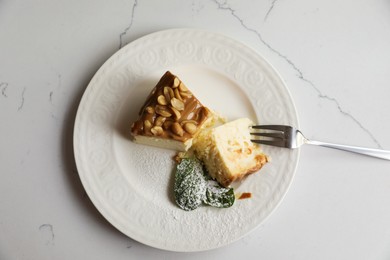 Photo of Tasty dessert and fork on white marble table, top view