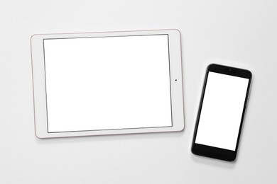 Photo of Modern tablet and smartphone on white background, flat lay. Space for text
