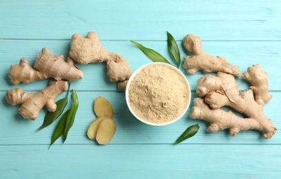 Photo of Flat lay composition with fresh and dry ginger on light blue wooden table