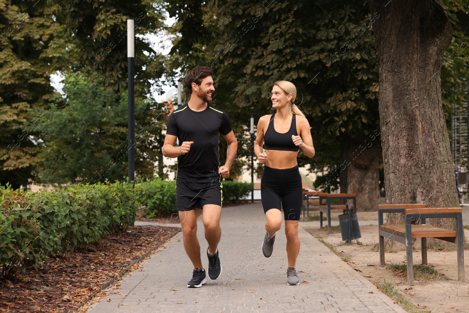 Photo of Healthy lifestyle. Happy couple running in park