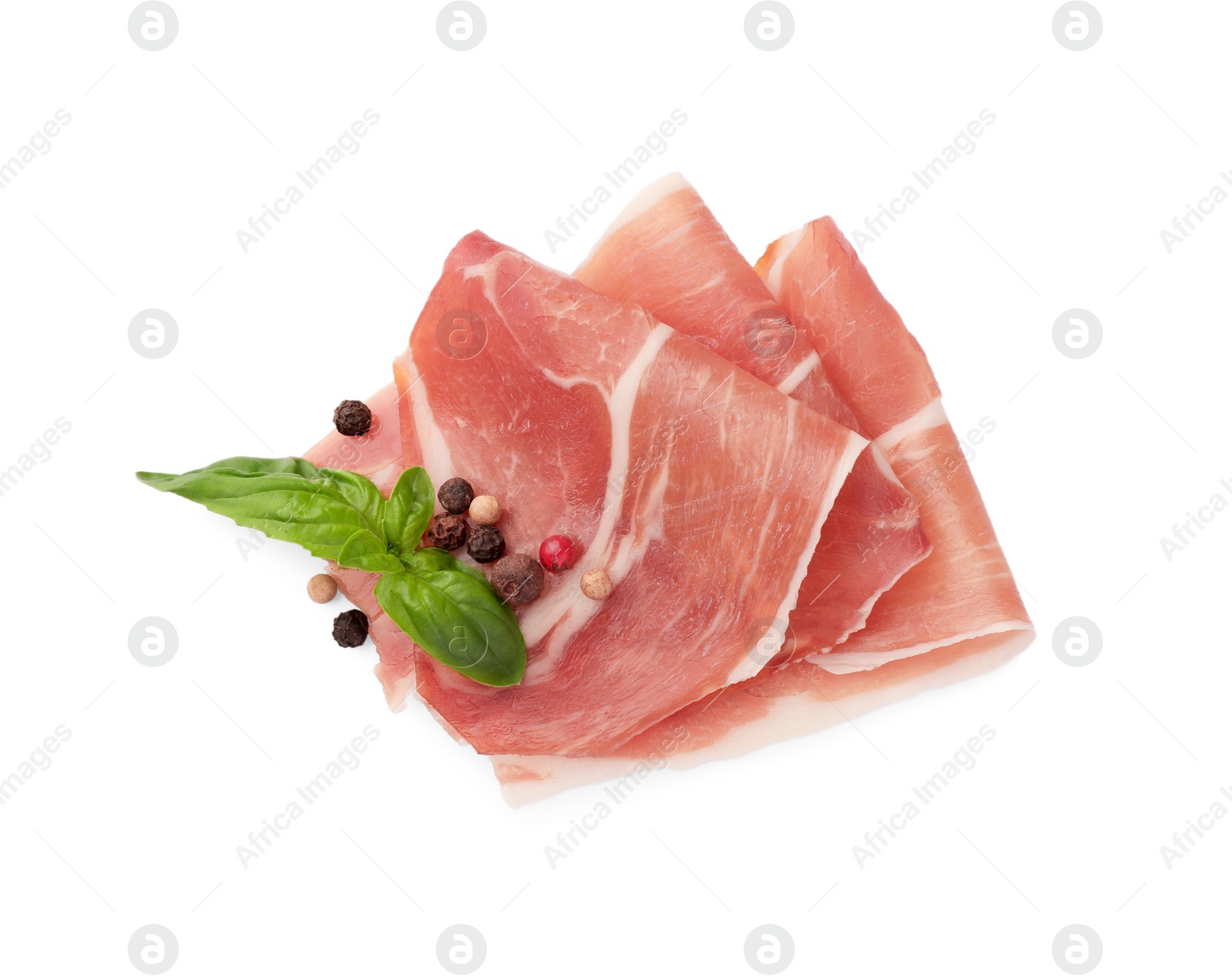 Photo of Slices of delicious jamon, spices and basil isolated on white, top view