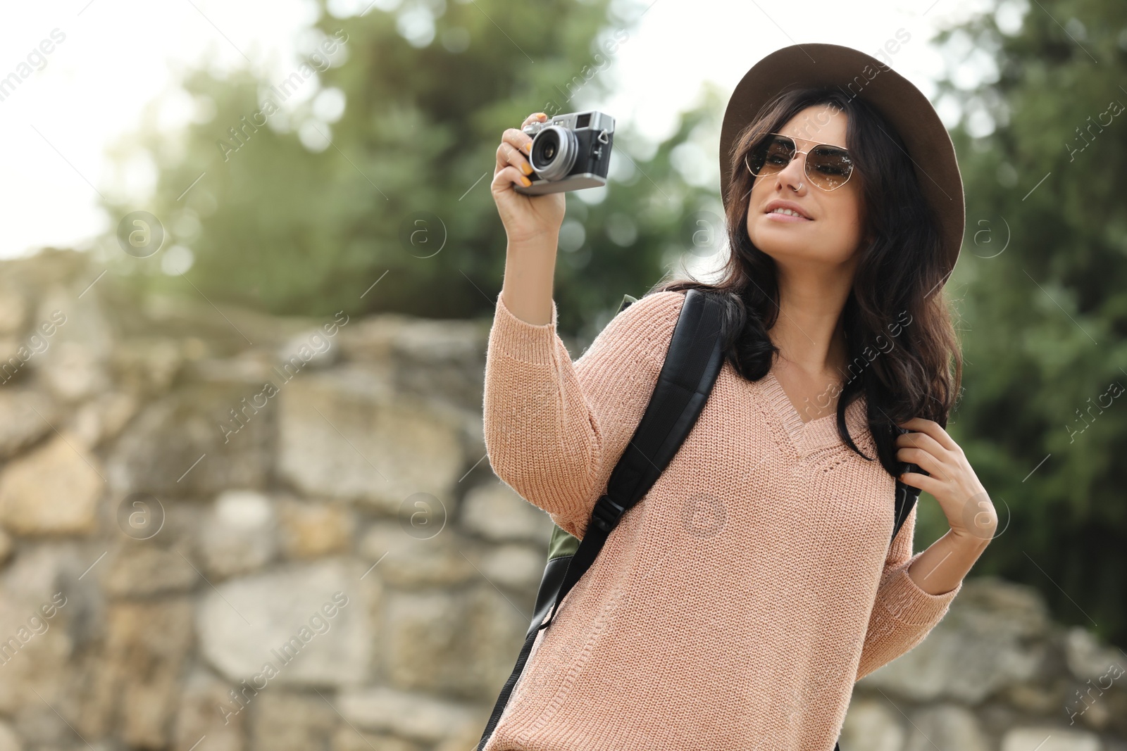 Photo of Traveler with photo camera on city street