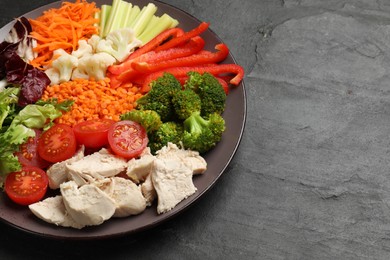 Photo of Balanced diet and healthy foods. Plate with different delicious products on black table, closeup. Space for text