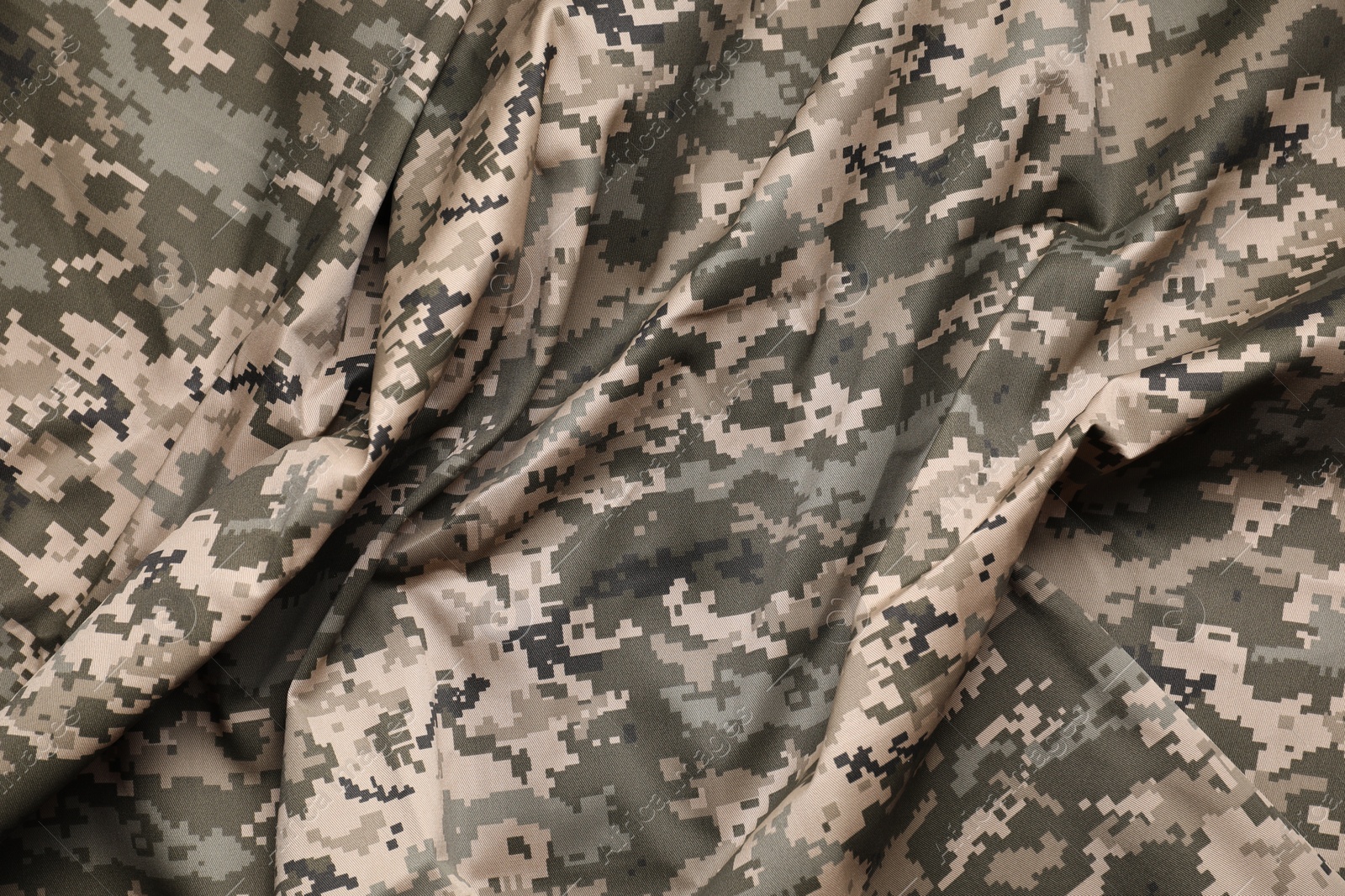 Photo of Texture of crumpled camouflage fabric as background, top view