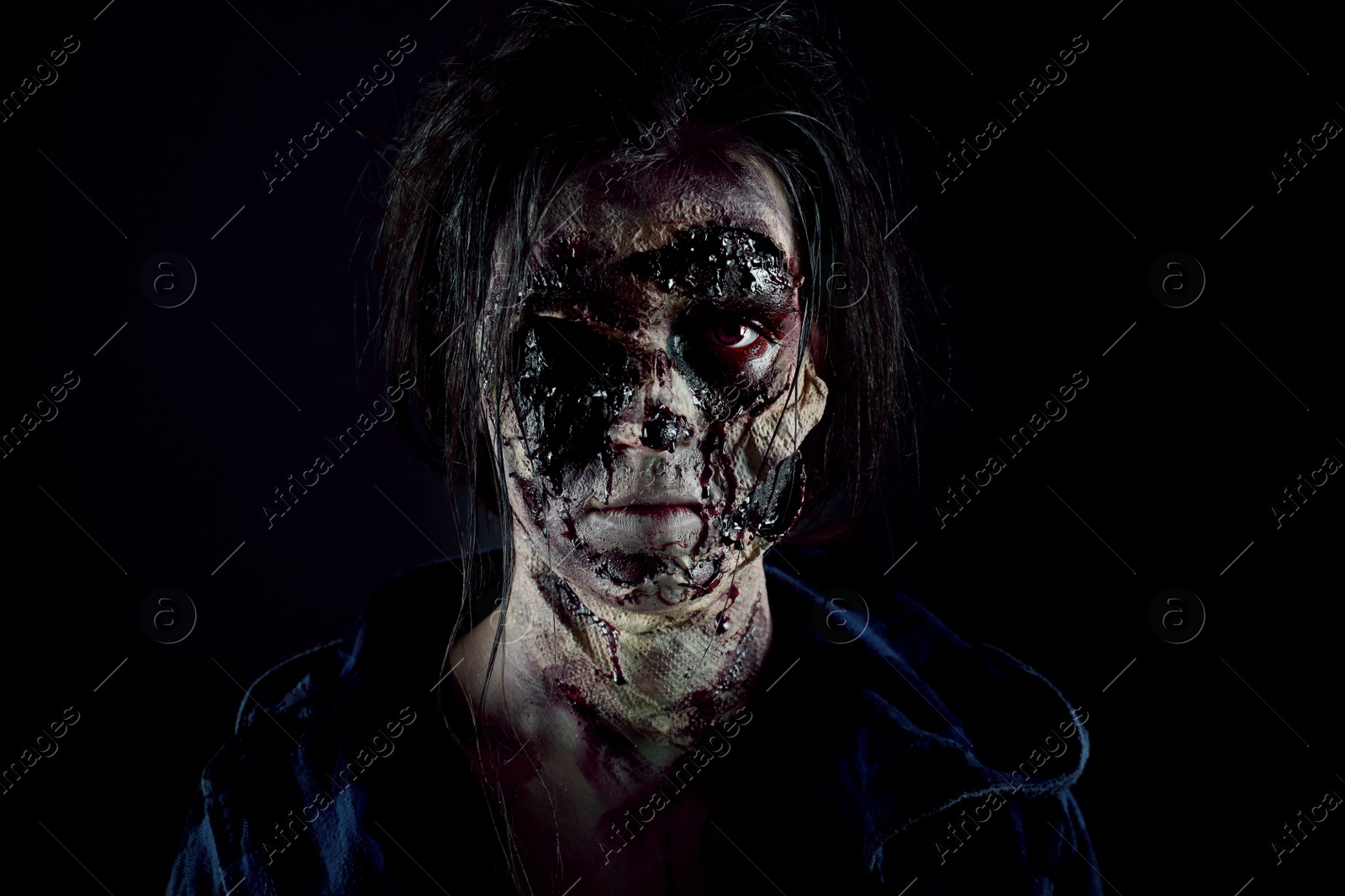 Photo of Scary zombie on dark background. Halloween monster