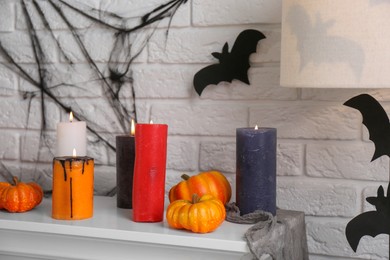 Fireplace with different Halloween decor indoors. Festive interior