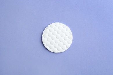 Photo of Cotton pad on color background, top view