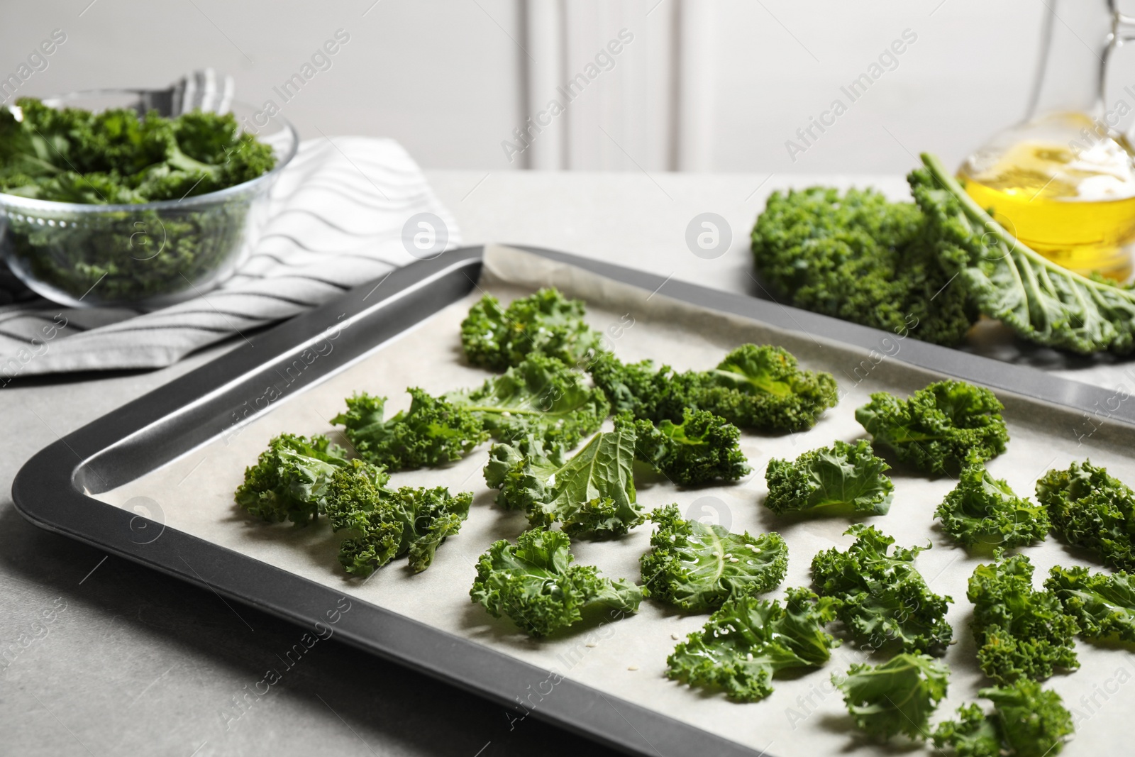 Photo of Raw cabbage leaves on grey table. Preparing kale chips