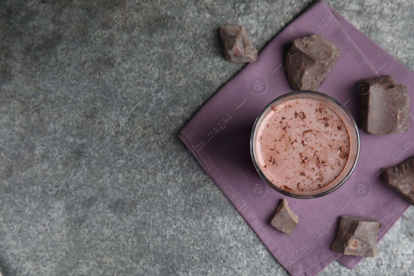 Photo of Delicious chocolate milk on grey table, flat lay. Space for text