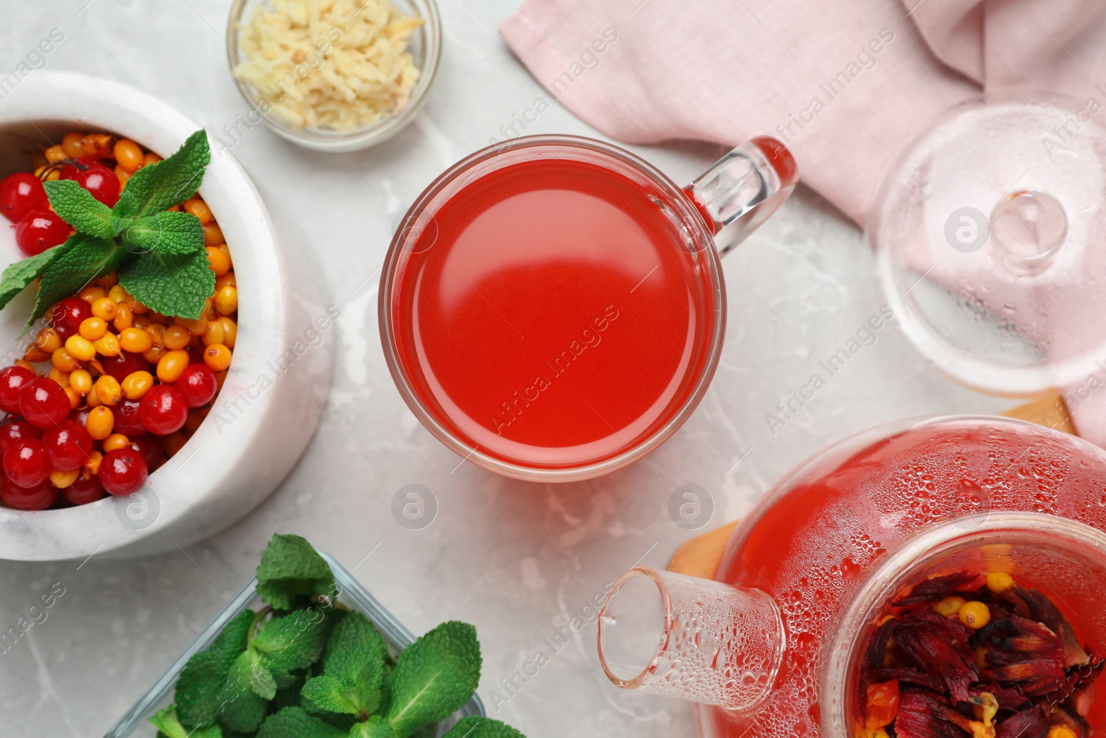 Photo of Flat lay composition with immunity boosting drink on light grey marble table 