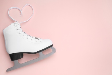 Photo of Skate on pink background, top view. Space for text