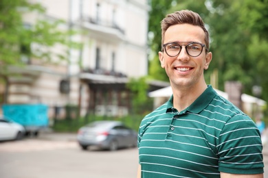 Photo of Portrait of attractive young man in stylish outfit outdoors