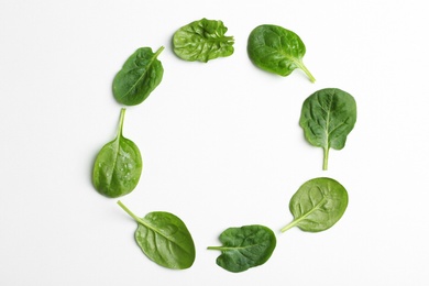 Photo of Frame made of spinach leaves on white background, top view. Space for text