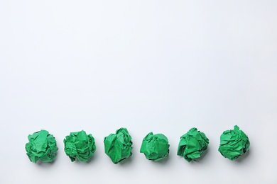 Photo of Colorful crumpled sheets of paper on white background, top view