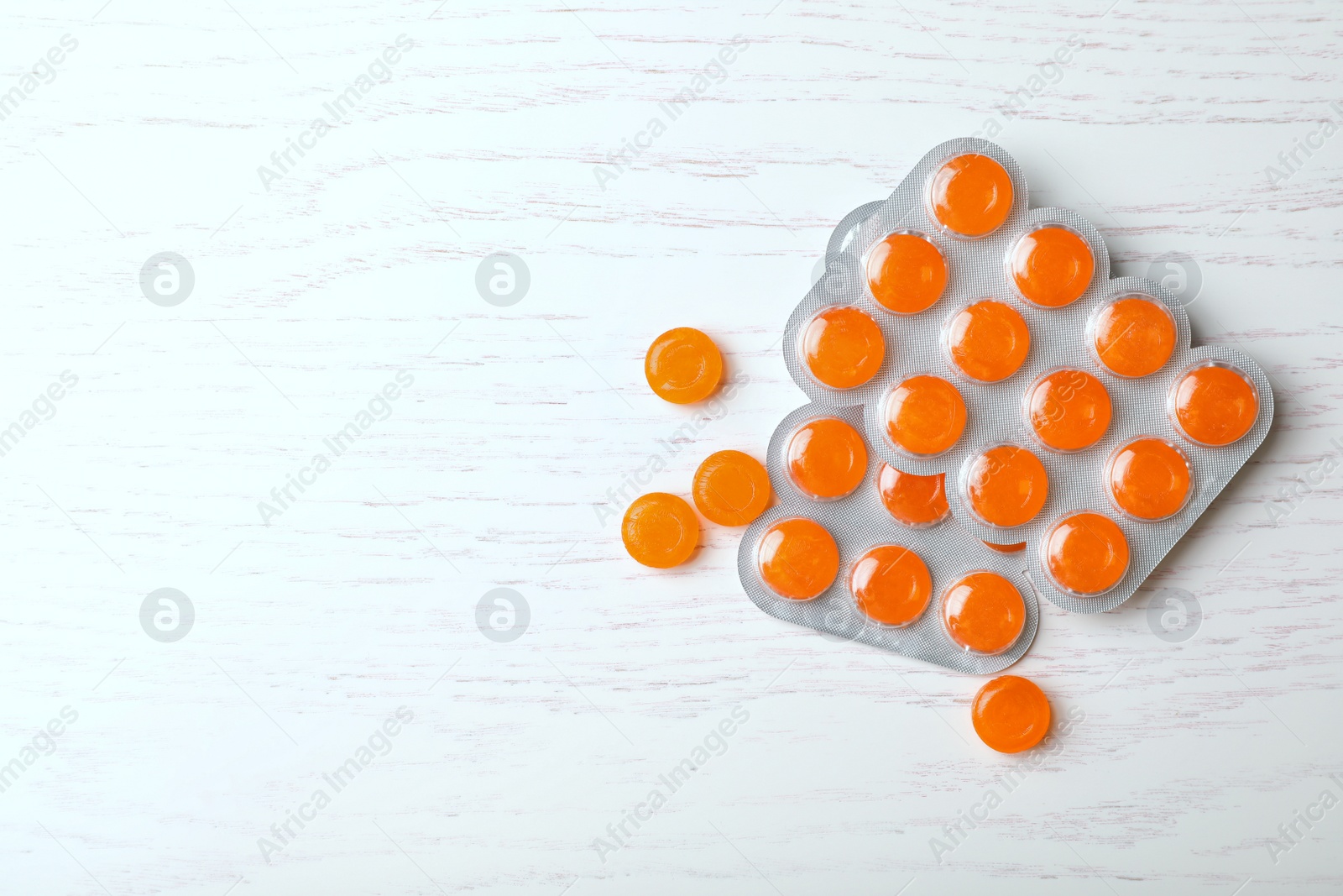 Photo of Color cough drops on grey background, top view. Space for text