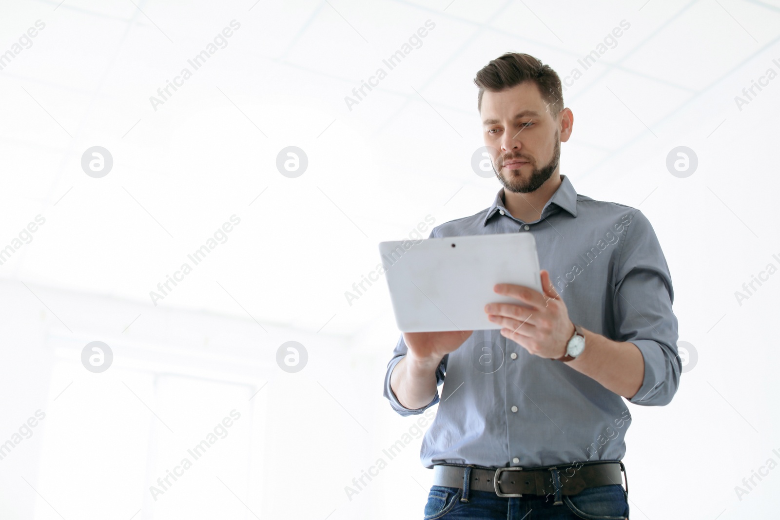 Photo of Male lawyer working with tablet in office