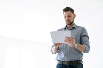 Male lawyer working with tablet in office