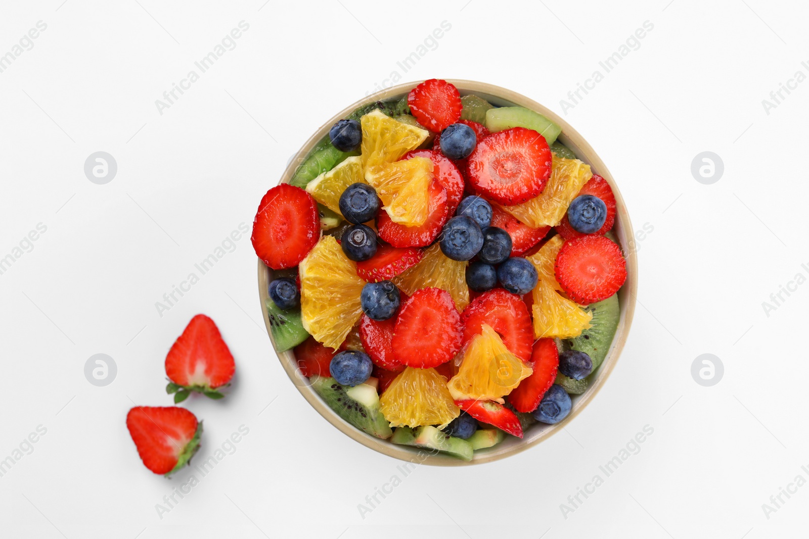 Photo of Yummy fruit salad in bowl on white background, top view