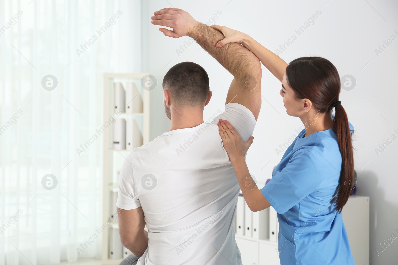 Photo of Doctor working with patient in hospital. Rehabilitation physiotherapy