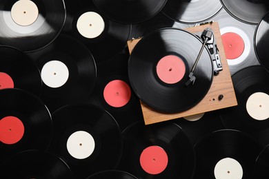 Modern player on vintage vinyl records, top view