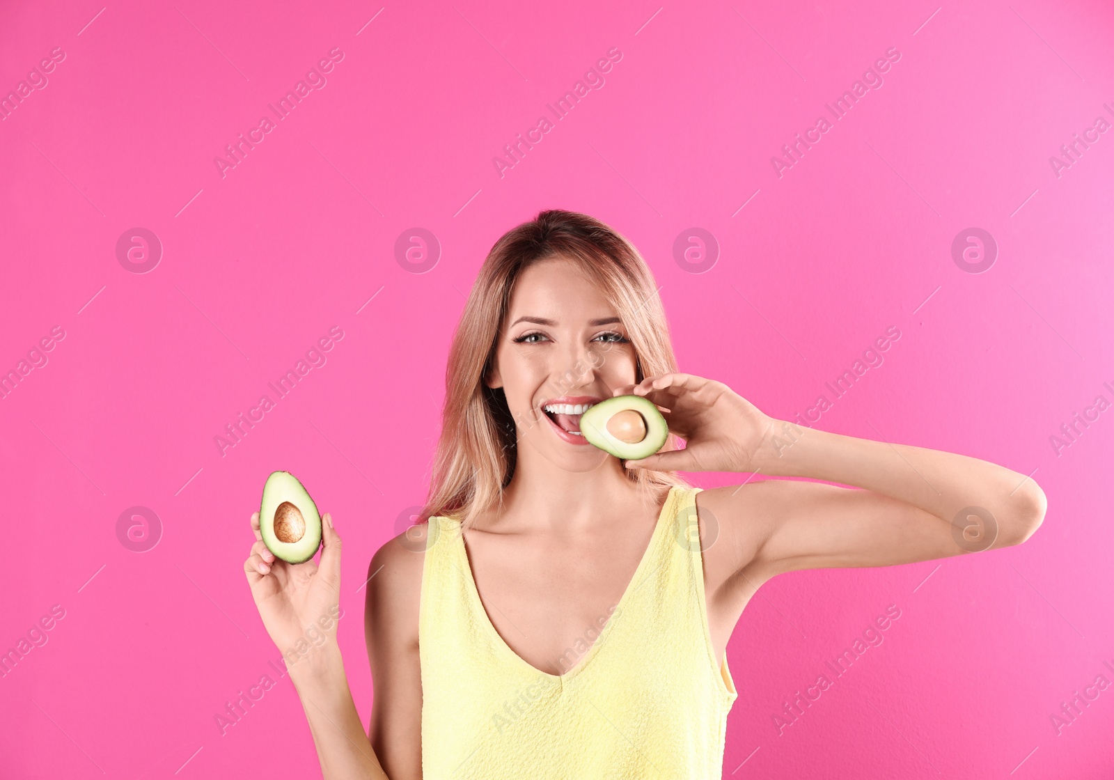 Photo of Portrait of young beautiful woman with ripe delicious avocado on color background