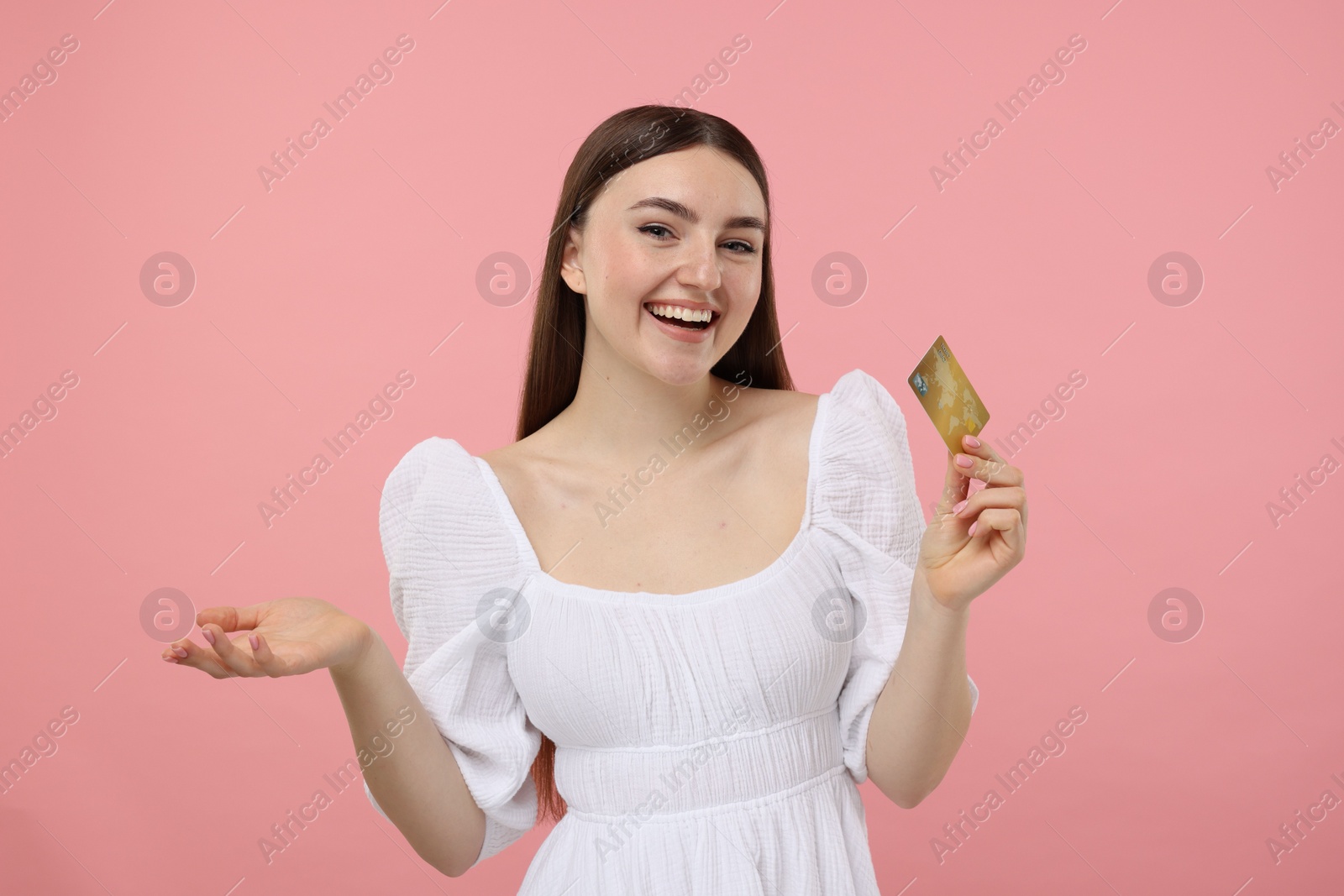 Photo of Happy woman with credit card on pink background