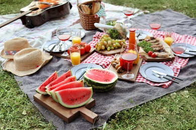 Photo of Blanket with food prepared for summer picnic outdoors