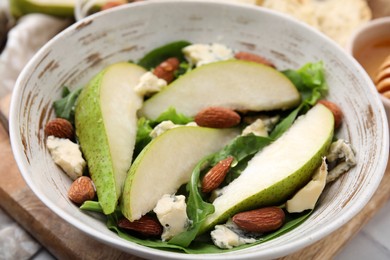 Photo of Delicious pear salad in bowl on table, closeup