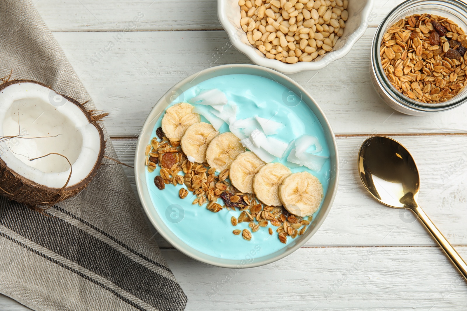 Photo of Flat lay composition with bowl of spirulina smoothie on wooden table