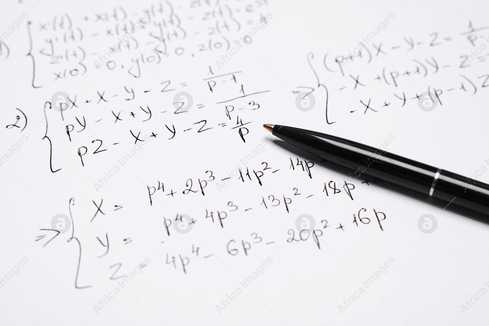 Photo of Sheet of paper with mathematical formulas and pen, closeup