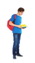 Photo of Handsome teenager boy with books on white background