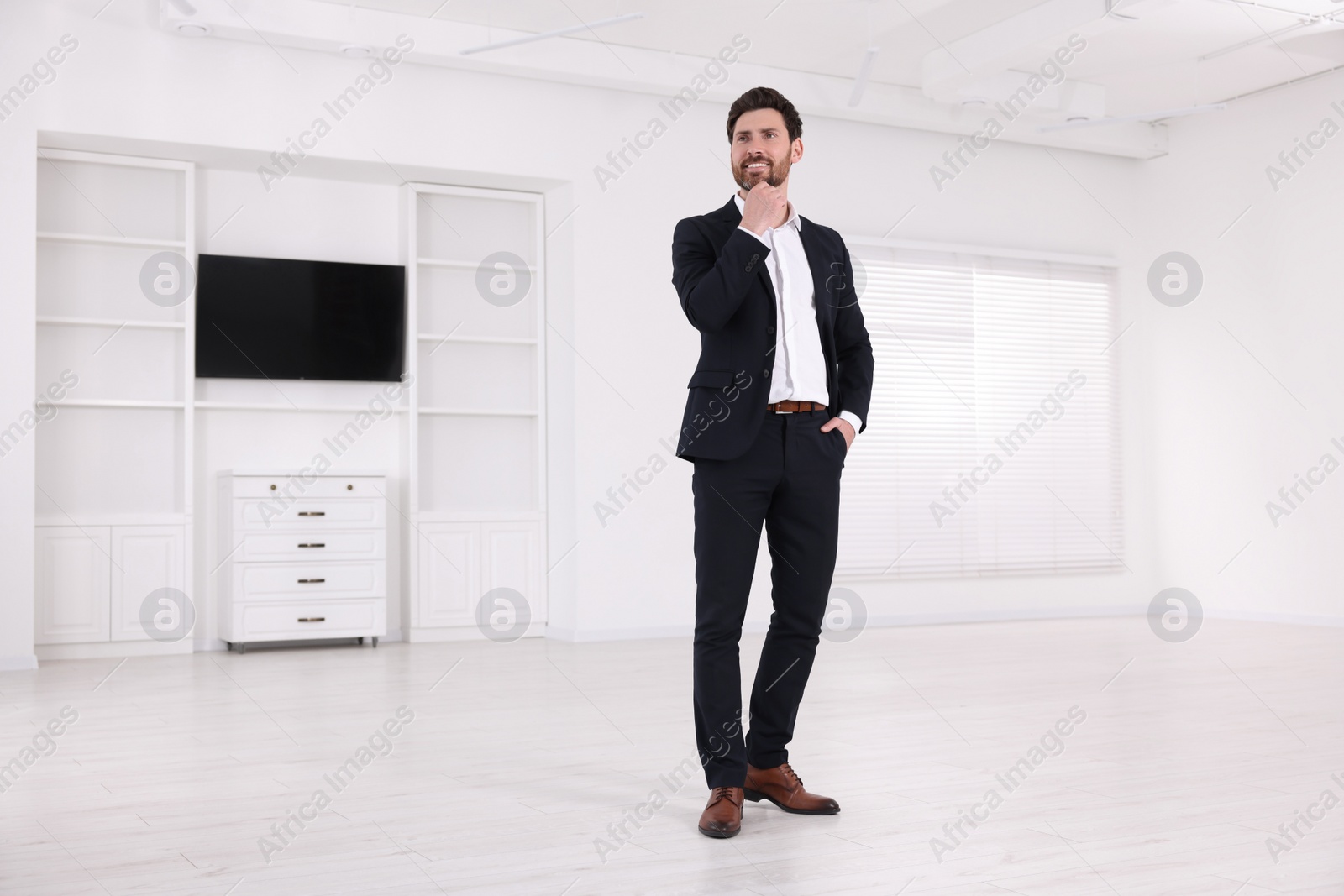 Photo of Happy real estate agent in new house