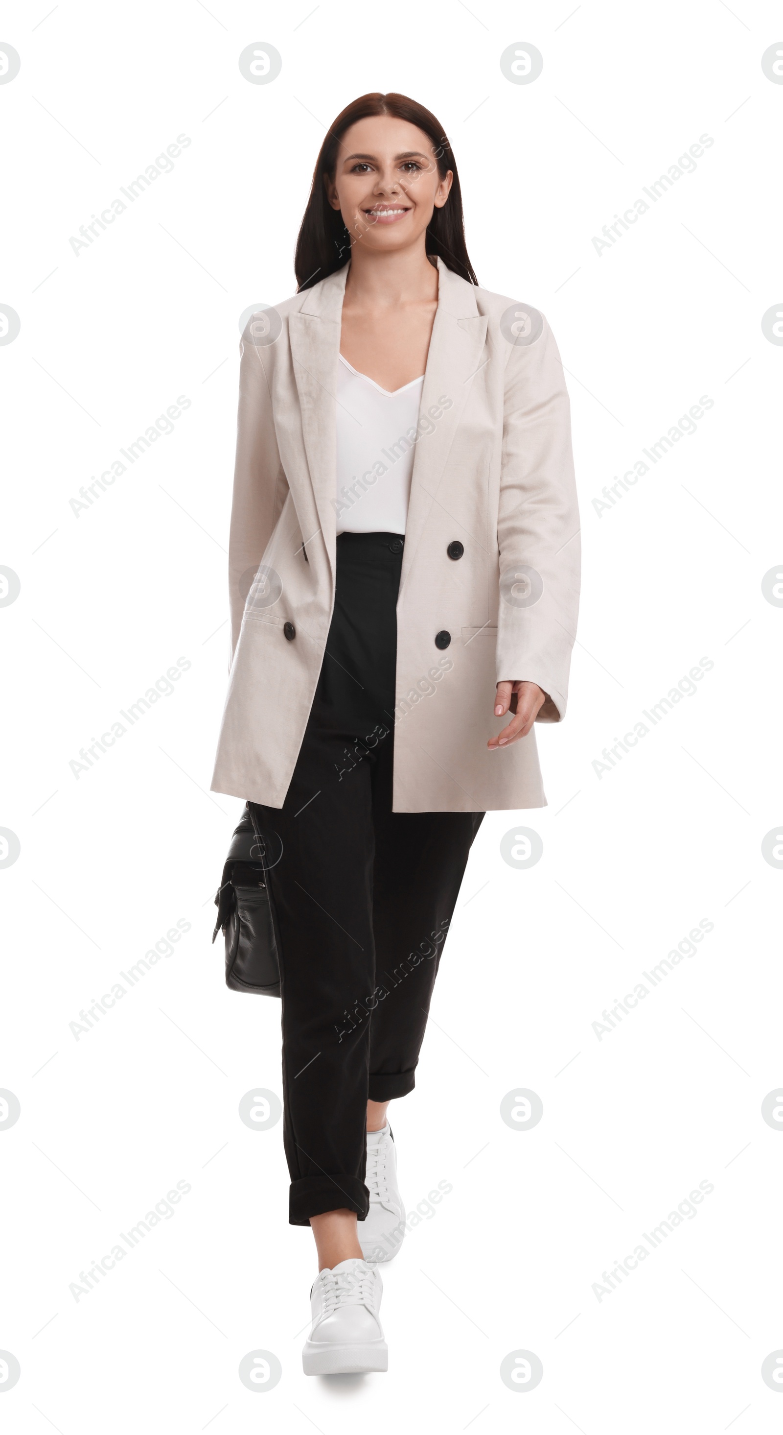 Photo of Beautiful businesswoman in suit with briefcase walking on white background