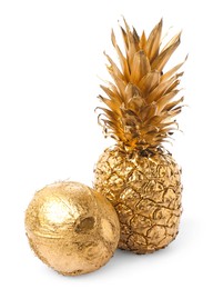 Shiny golden pineapple and coconut on white background
