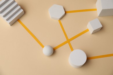 Photo of Business process organization and optimization. Scheme with geometric figures on beige background, above view