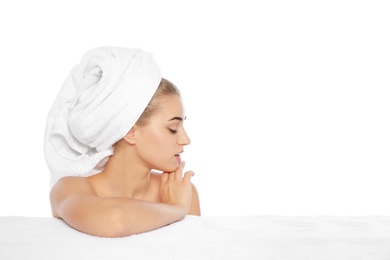 Portrait of young pretty woman with towel on white background