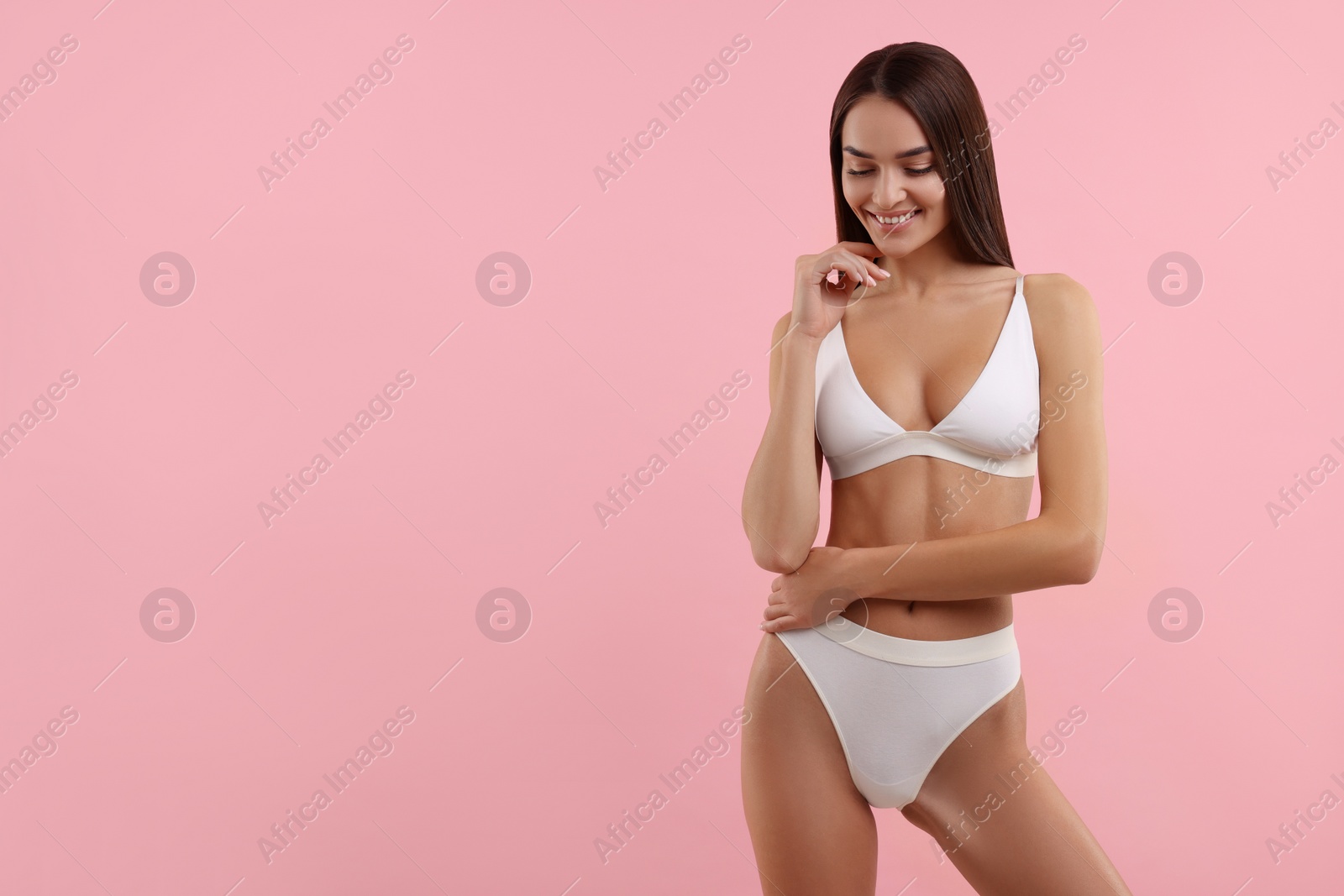 Photo of Young woman in stylish white bikini on pink background. Space for text