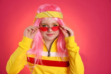 Photo of Cute indie girl with sunglasses on bright pink background, space for text