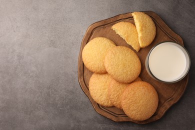 Delicious Danish butter cookies and milk on grey table, top view. Space for text