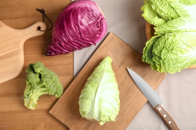 Different fresh cabbages on table, top view. Healthy food