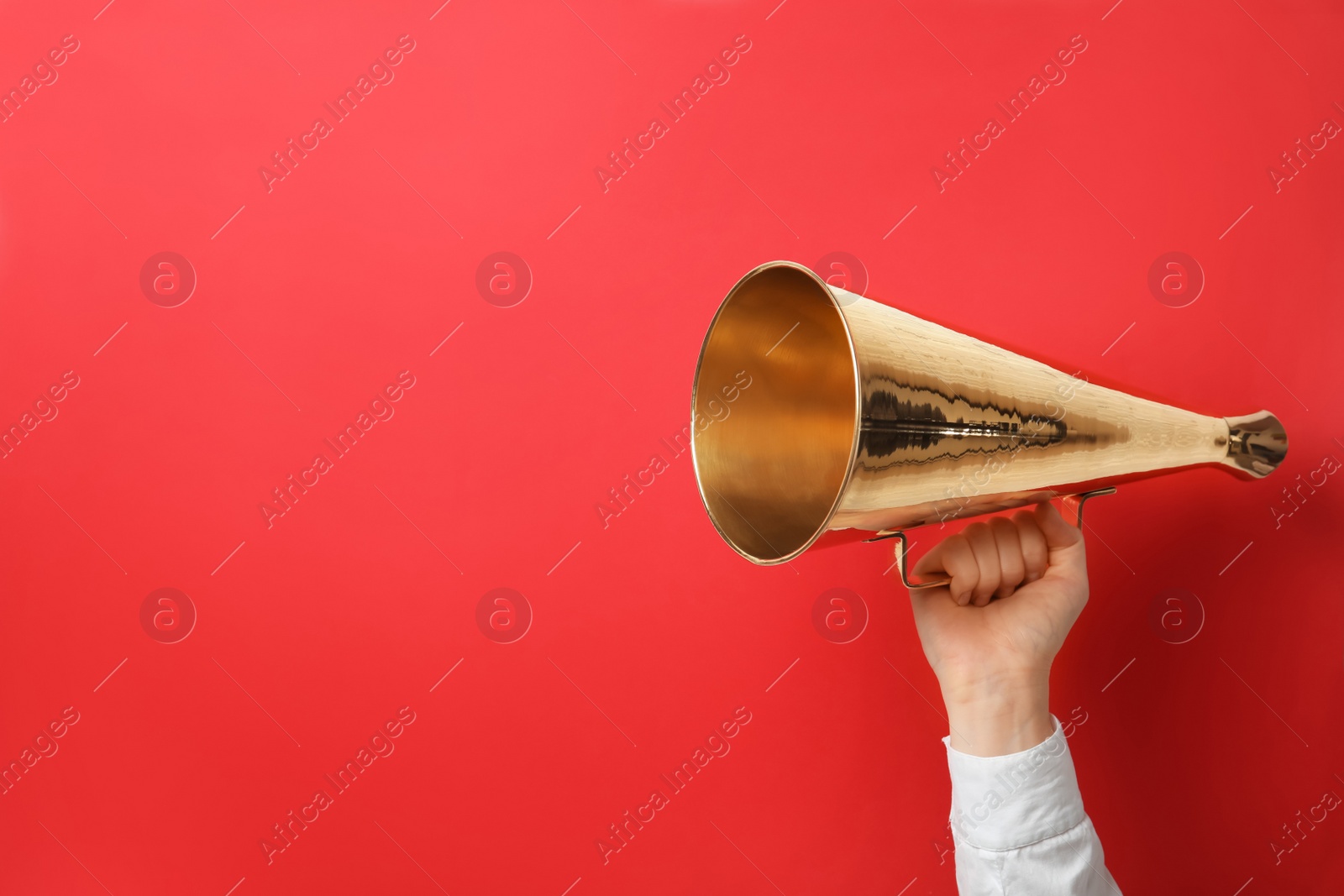 Photo of Woman holding retro megaphone on color background